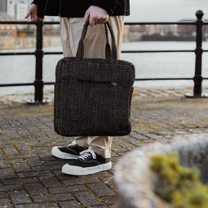 Someone Carrying a Hand Woven Laptop Bag in Their Hand